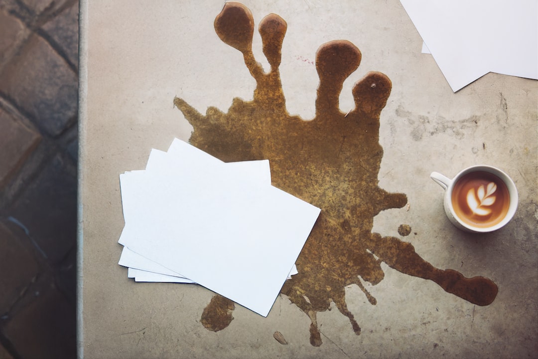 a-table-topped-with-papers-and-a-cup-of-coffee-vi6nbgvpkxy